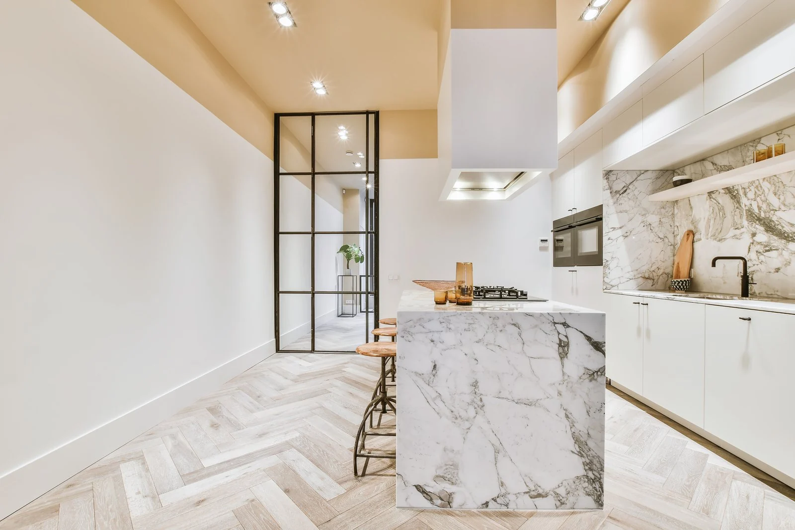 Luxury white kitchen with marble island and black architectural details