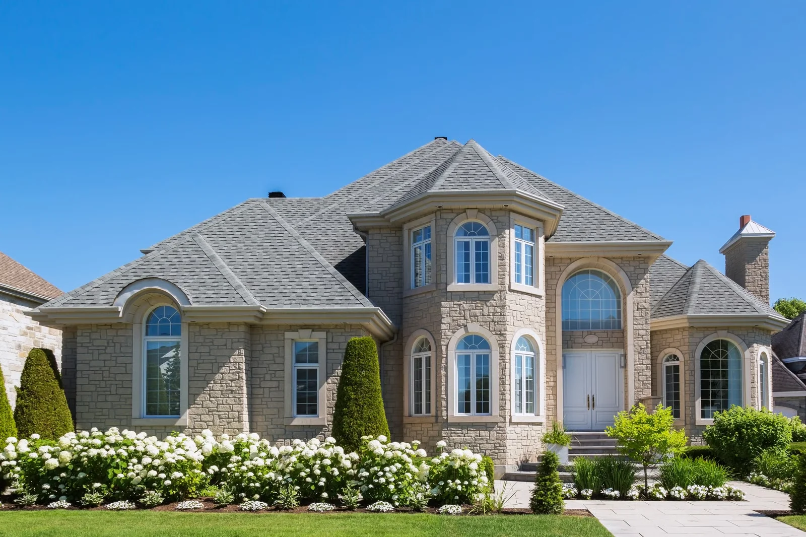 Luxury stone residence with manicured landscaping